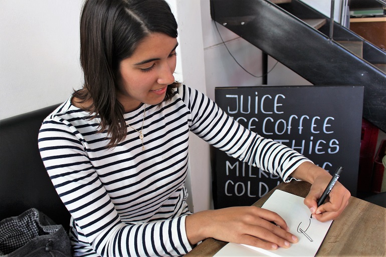 Katie, sketching a coffee glass at Cafe Fiol